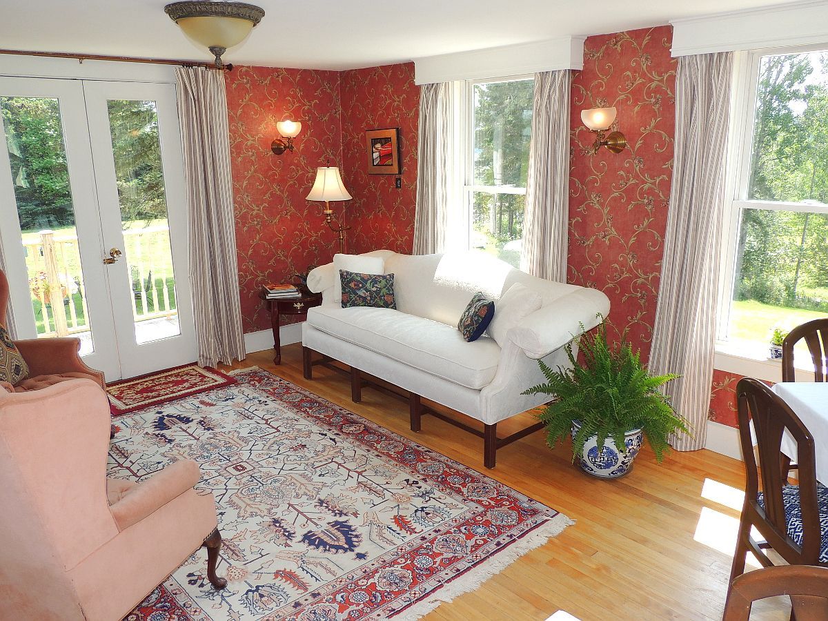 A living room with a couch a chair and a rug