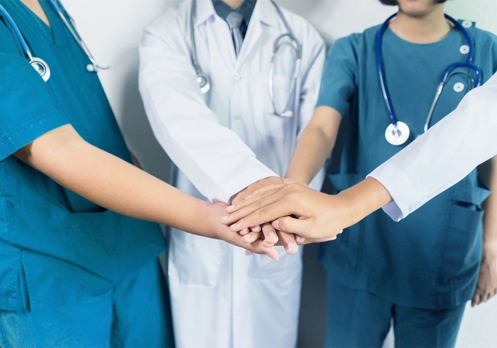 Doctors and nurses coordinate hands. Concept Teamwork, happy doctors working together as team for motivation, success medical health care