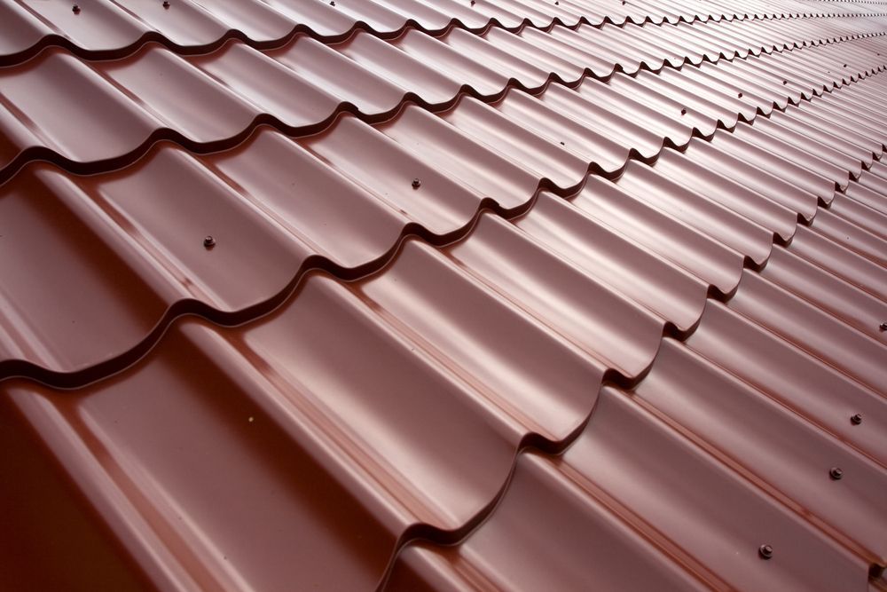 Close-up of a Brown Metal Roof With a Wavy Pattern, Reflecting Light — Coffs Coast Roofing In Nambucca, NSW