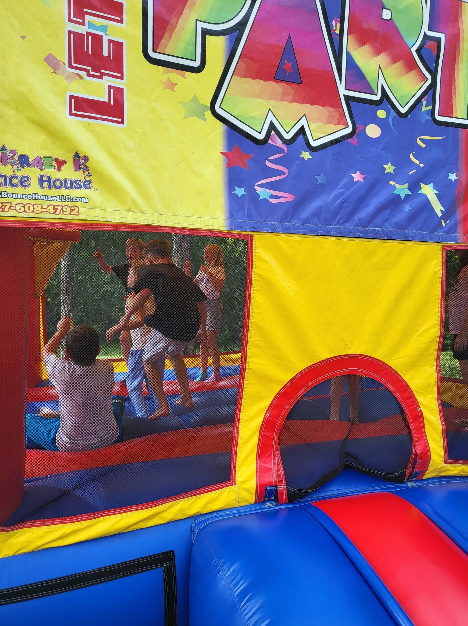 A group of children are playing in a bouncy house.