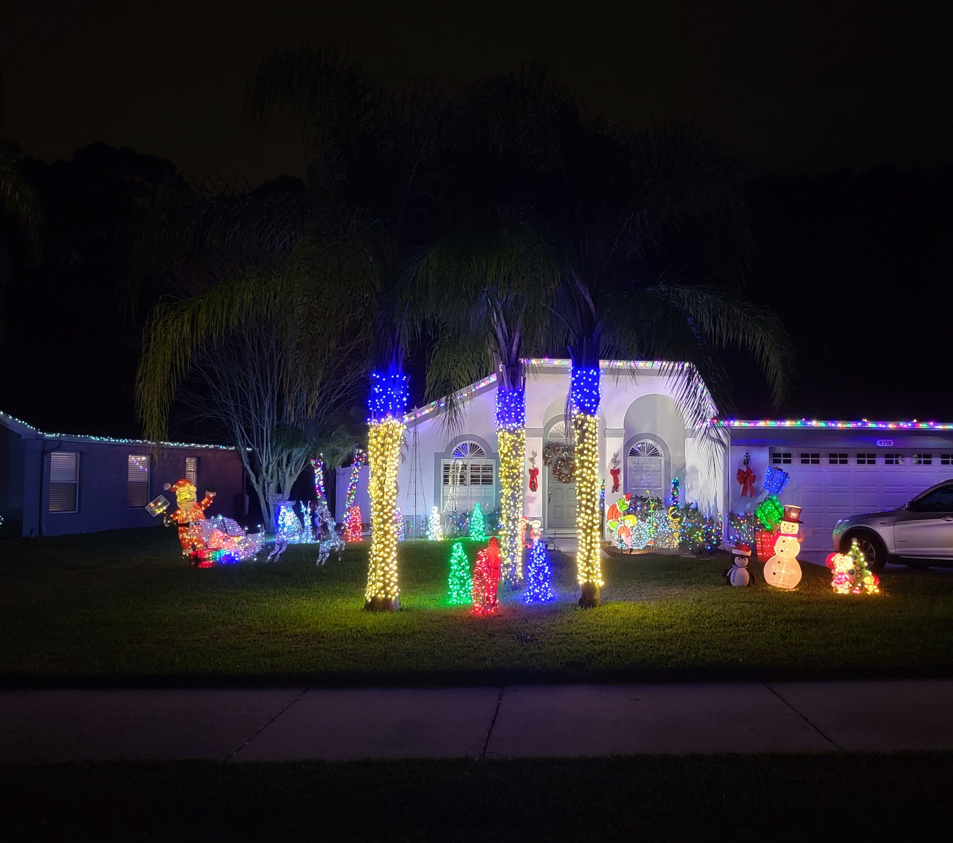 A house is decorated with christmas lights at night.