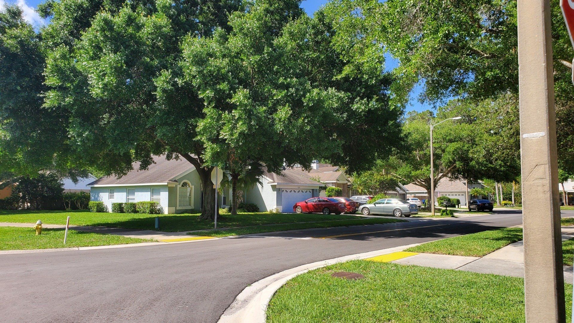 A stop sign is in the middle of a residential street.