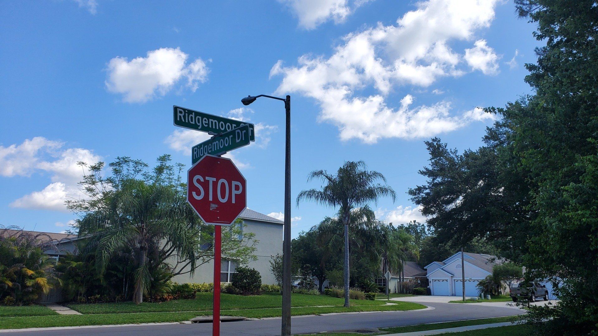 A stop sign is in the middle of a residential street