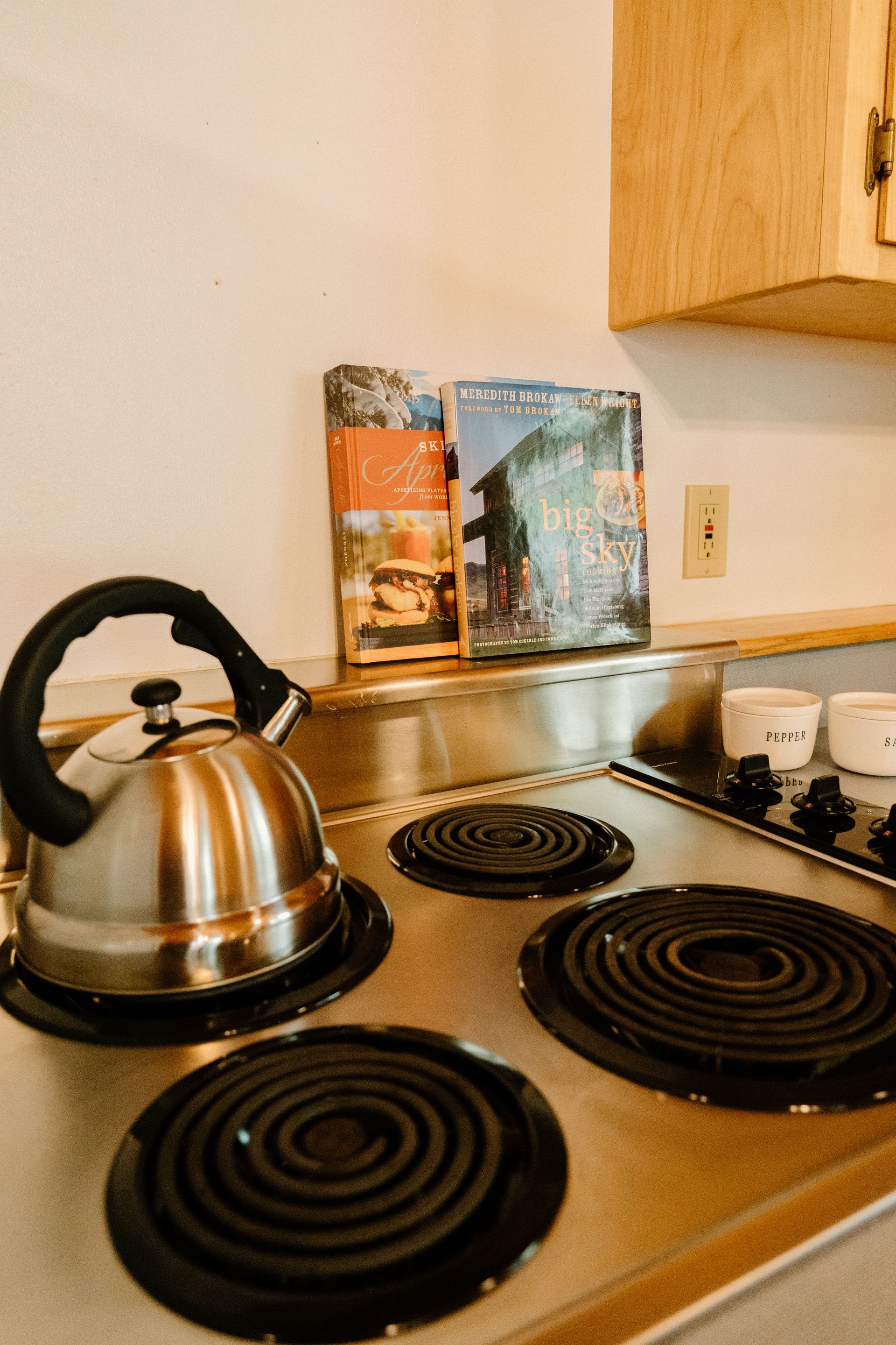 A kettle is sitting on top of a stove in a kitchen.