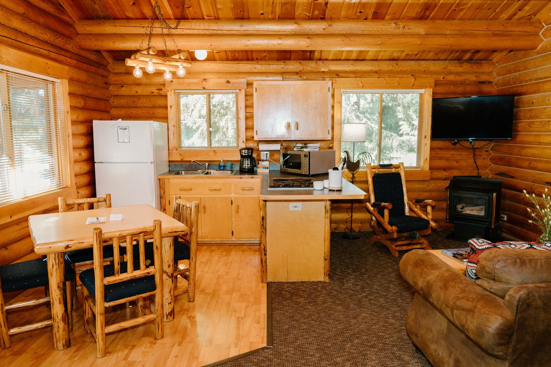 A log cabin with a kitchen , dining room and living room.