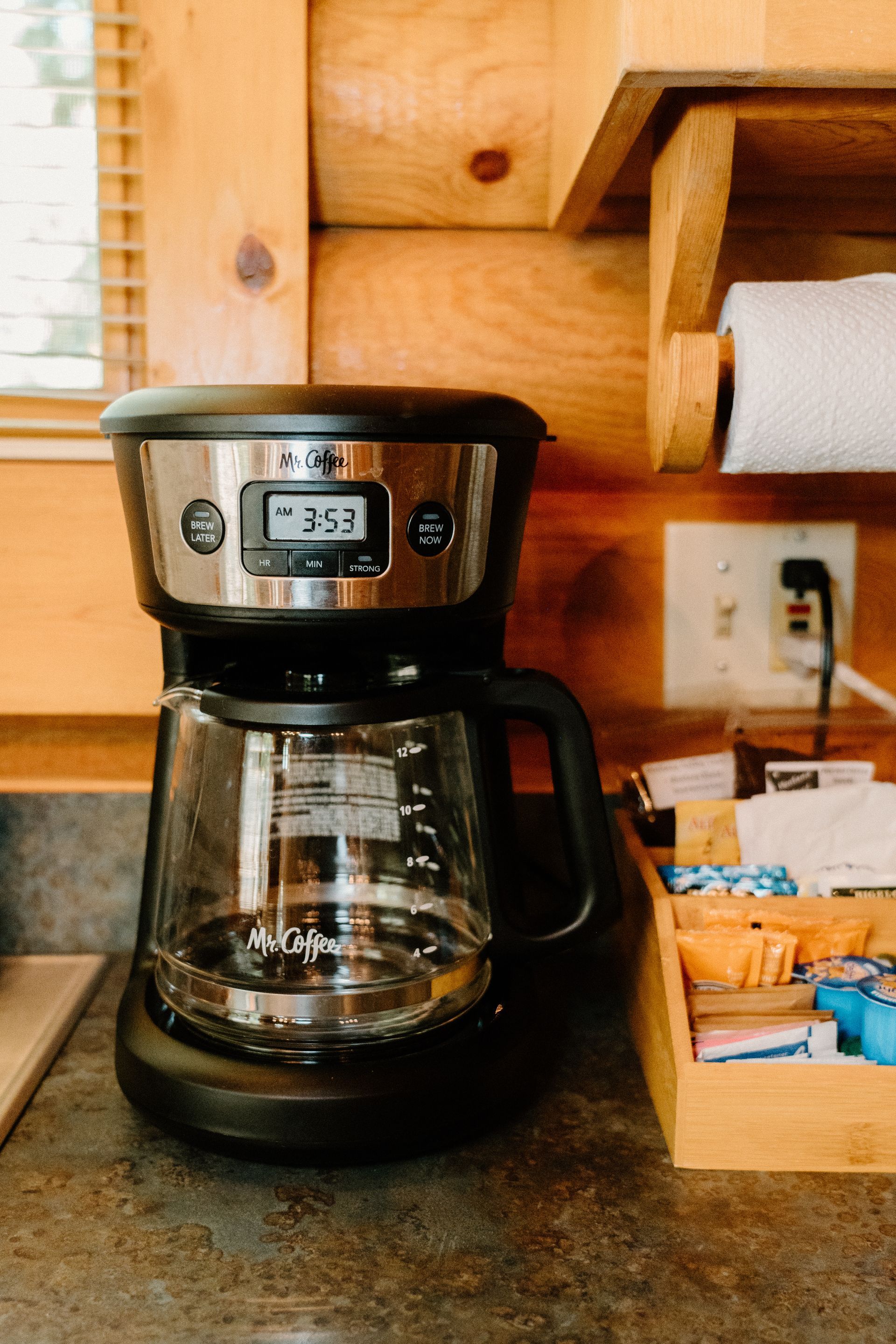 A coffee maker is sitting on a counter in a kitchen.