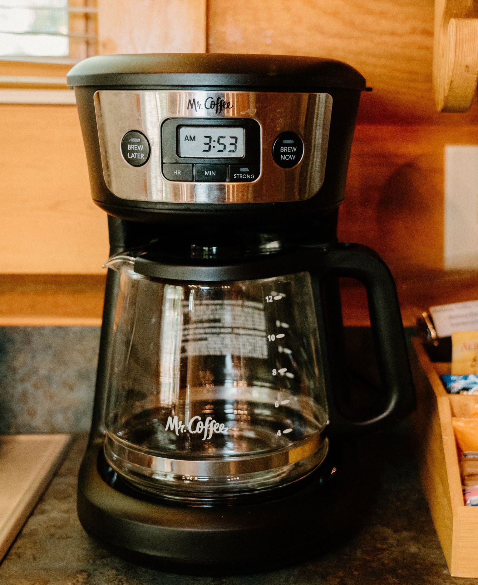 A coffee maker is sitting on a counter in a kitchen.