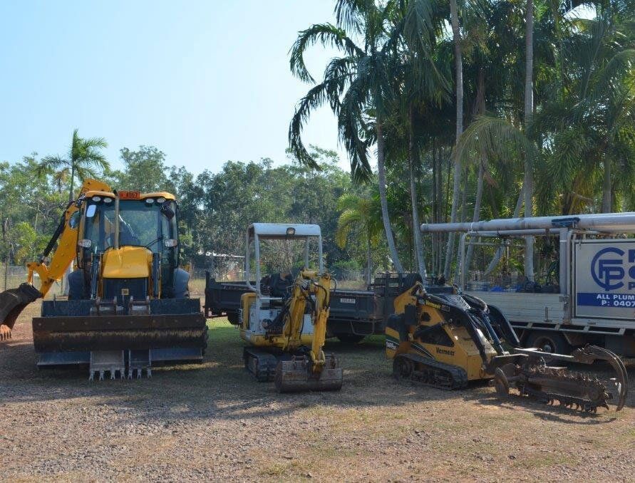 A Group of Construction Vehicles Are Parked in a Gravel Lot — Fastcall Group In Herbert, NT