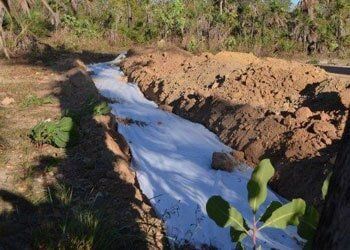 A White Tarp is Covering a Small Stream in the Middle of a Dirt Field — Fastcall Group In Herbert, NT