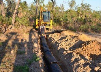 A Yellow Bulldozer is Digging a Pipe in the Dirt — Fastcall Group In Herbert, NT