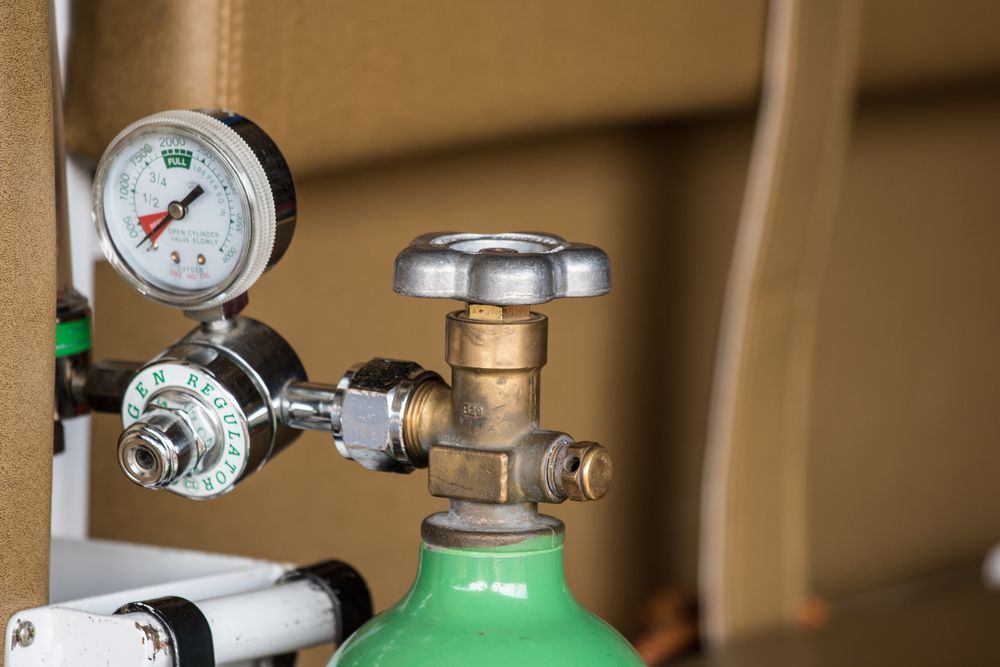 A Close Up of an Oxygen Cylinder With a Gauge Attached to It — Fastcall Group In Herbert, NT