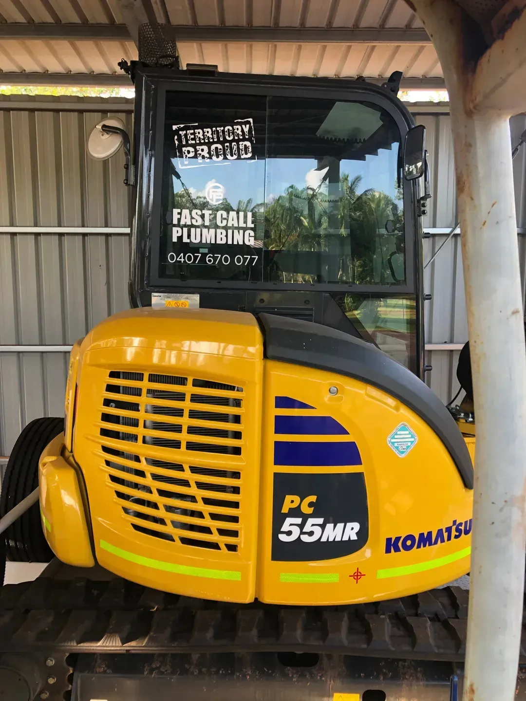 A Excavator is Parked Under a Shed — Fastcall Group In Herbert, NT