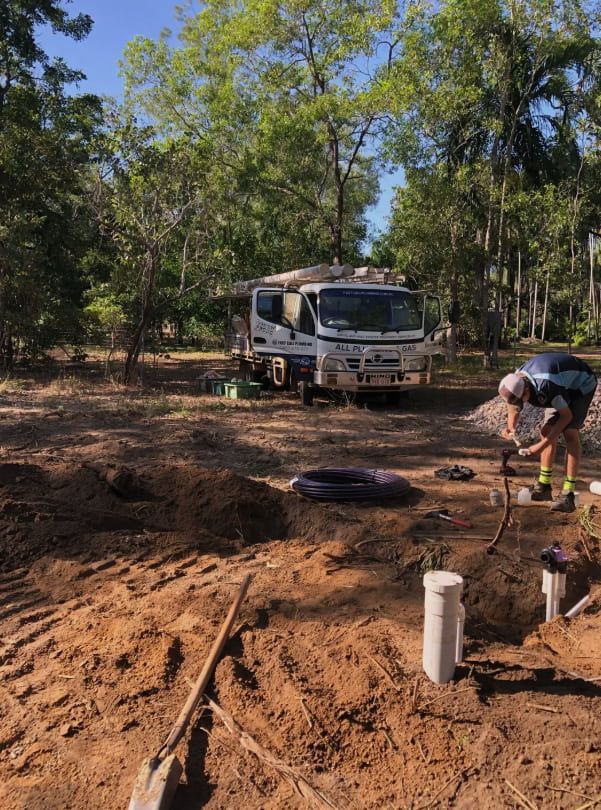A Man is Digging in the Dirt in Front of a Truck — Fastcall Group In Herbert, NT