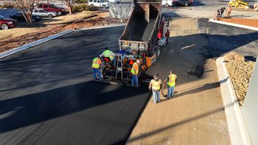 Construction site is laying new asphalt road pavement