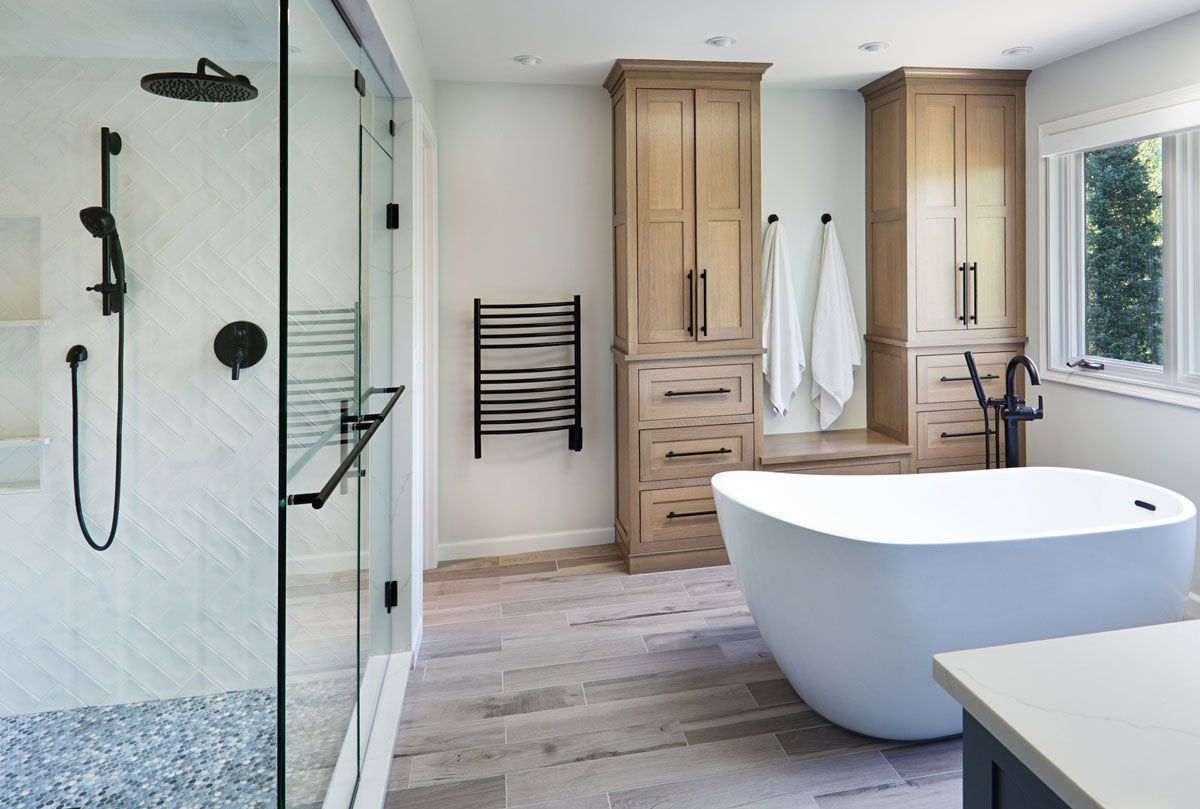 A bathroom with a bathtub and a walk in shower.