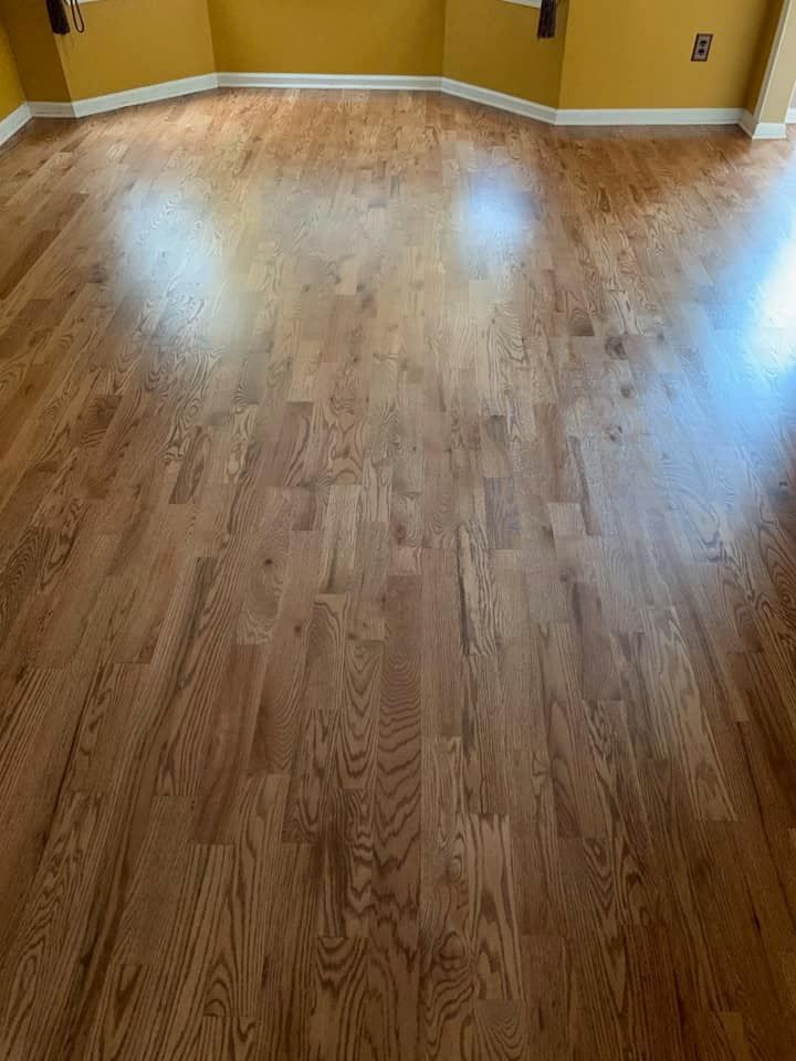 A living room with hardwood floors and yellow walls.