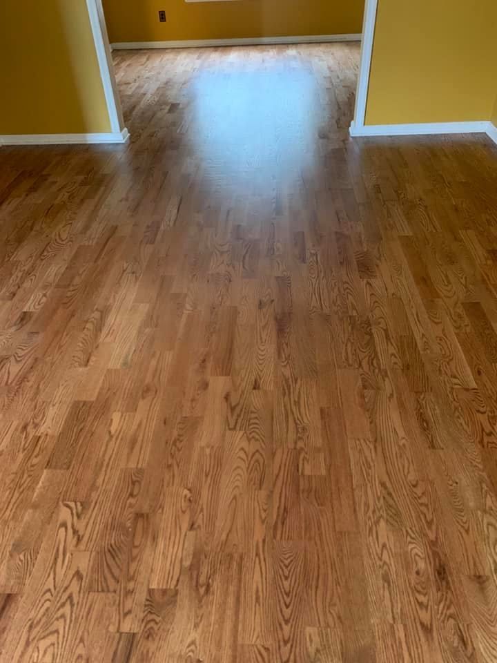 A living room with hardwood floors and yellow walls.