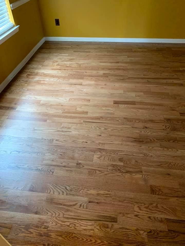 A room with hardwood floors and yellow walls.