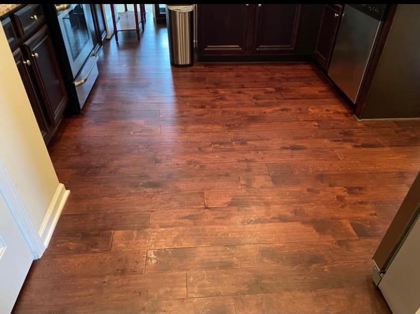A kitchen with hardwood floors and stainless steel appliances