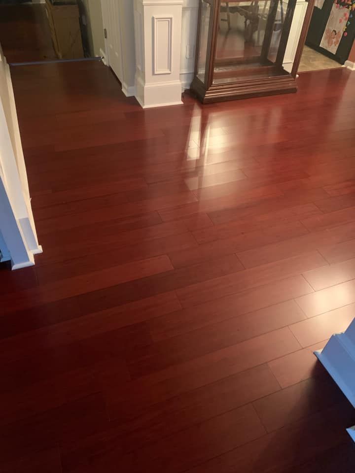 A living room with hardwood floors and a fireplace.
