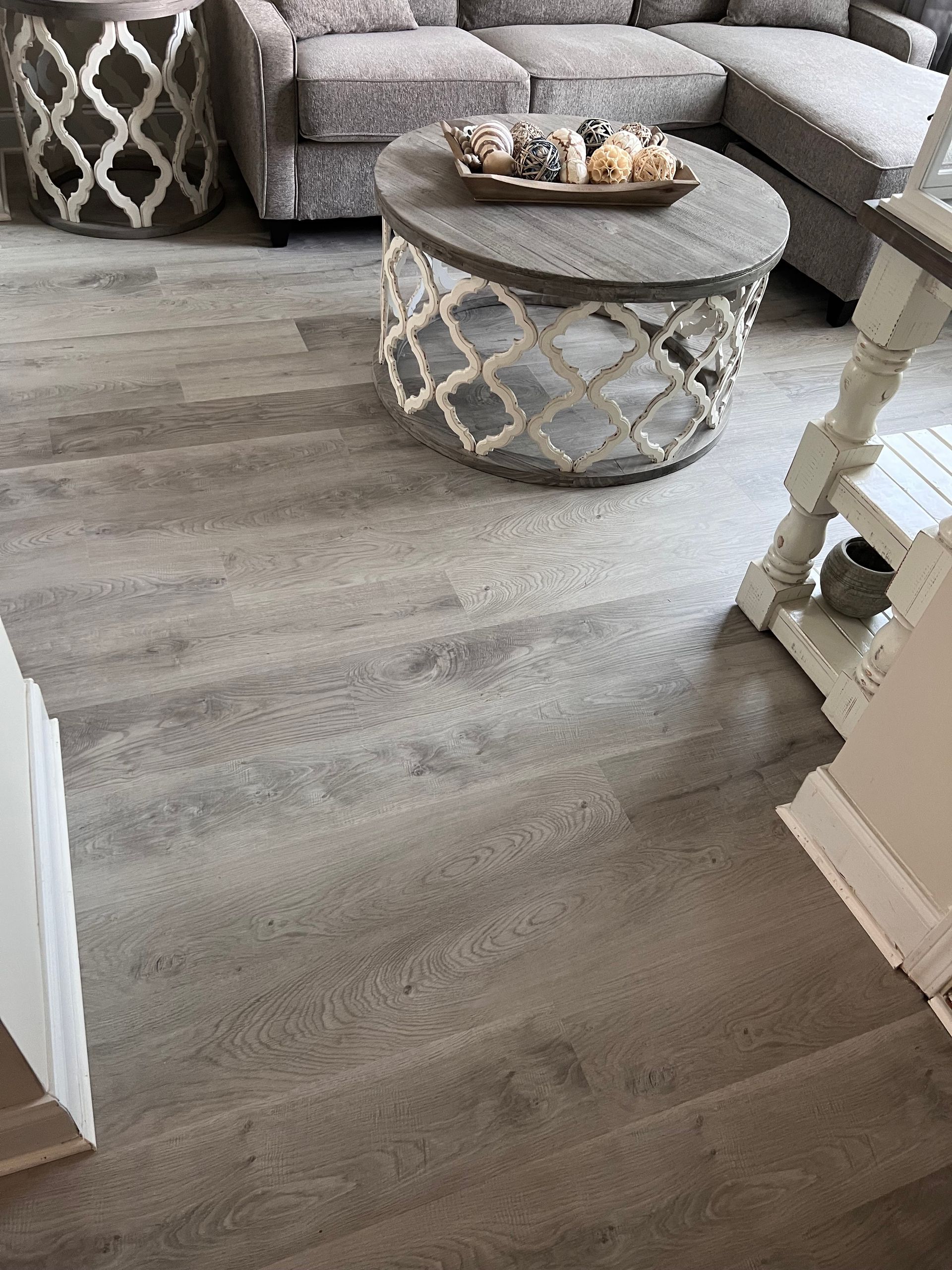 A living room with a round coffee table and a couch.