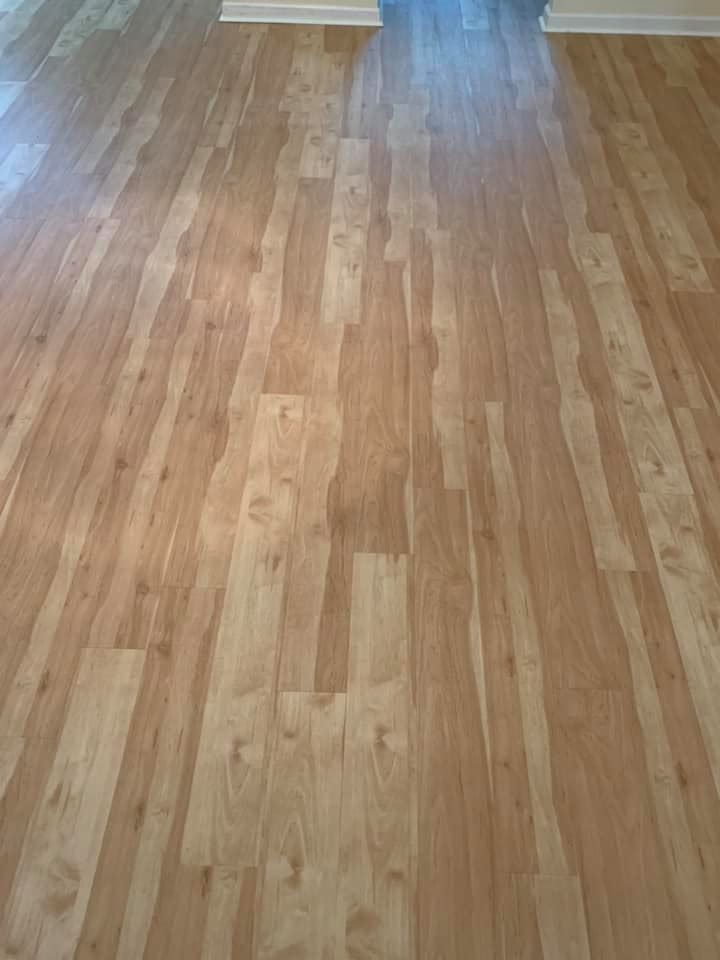 A close up of a wooden floor in a living room.