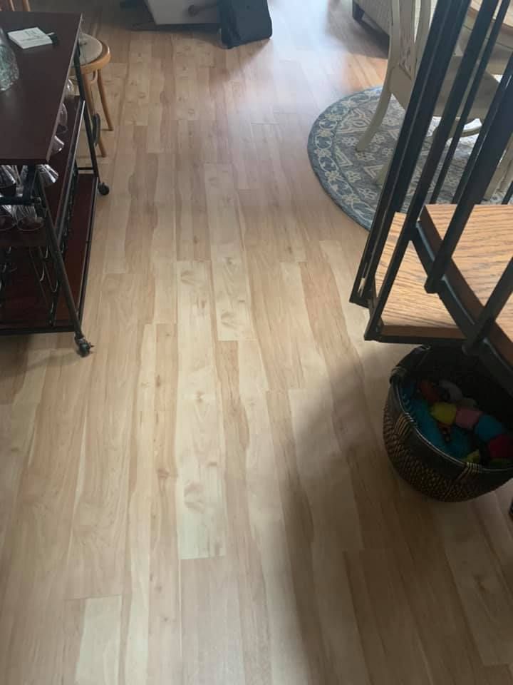 A living room with hardwood floors and a spiral staircase.