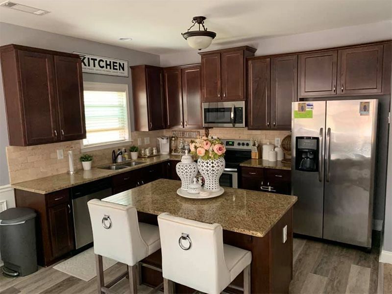 A kitchen with stainless steel appliances and granite counter tops.