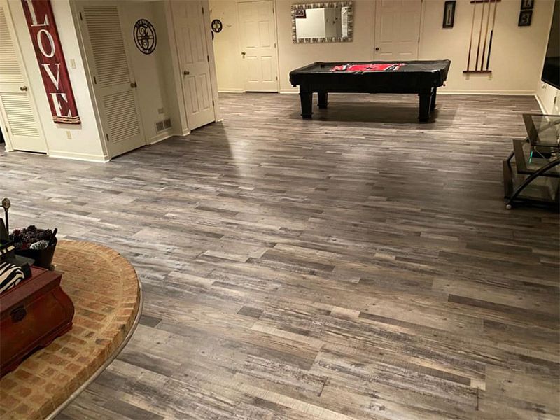 There is a pool table in the middle of the room.