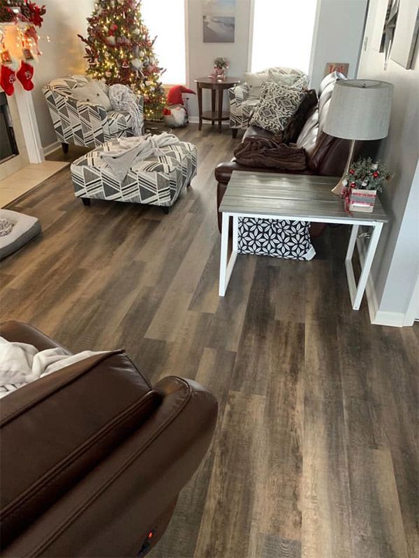 A living room filled with furniture and a christmas tree.