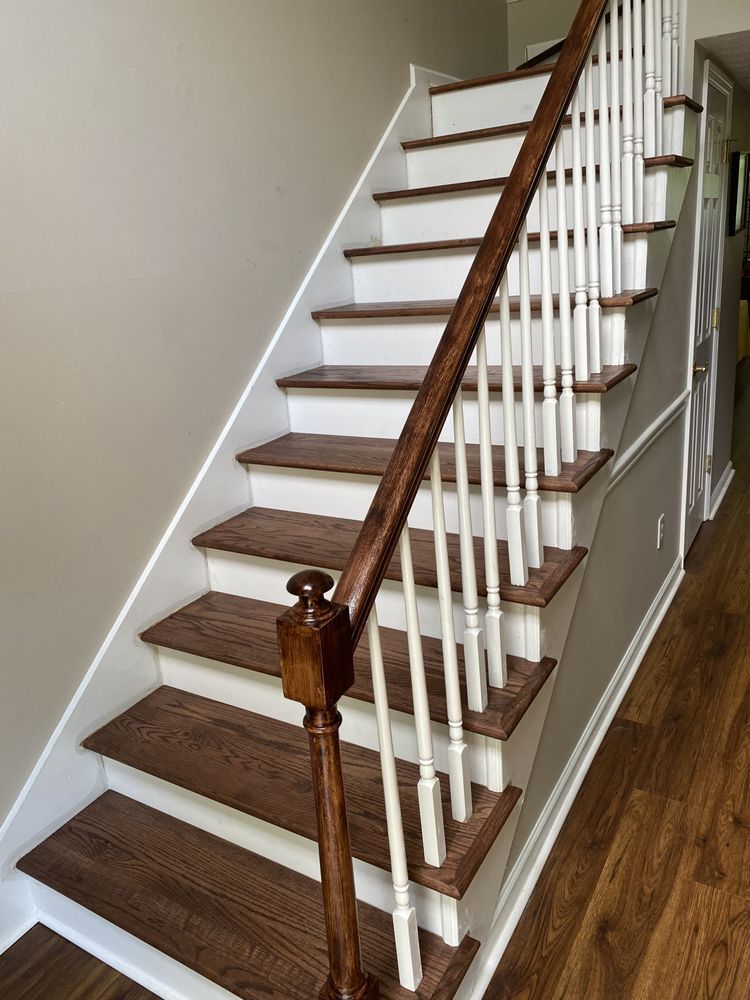 A staircase with wooden steps and white railings in a house.