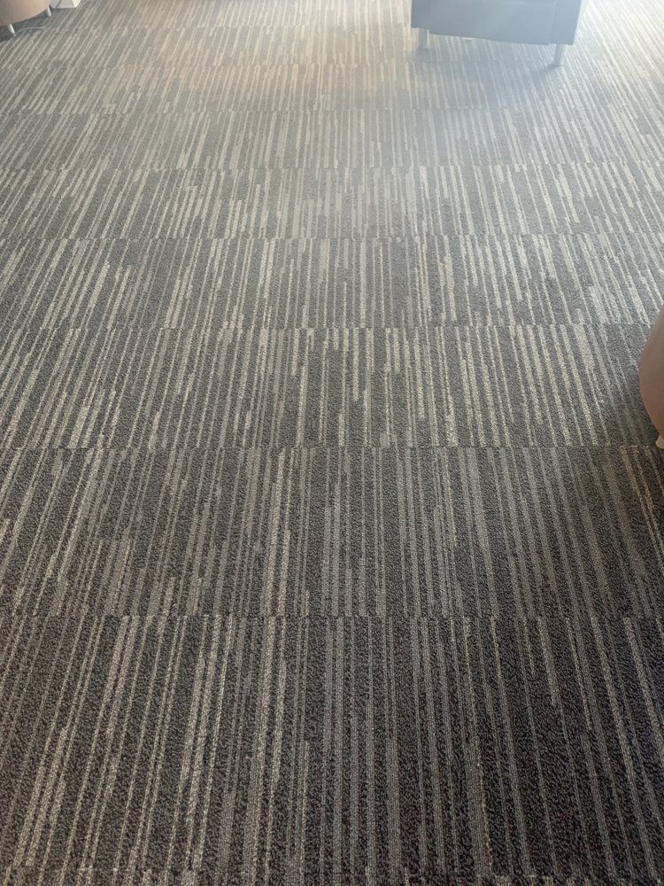 A close up of a striped carpet in a room.