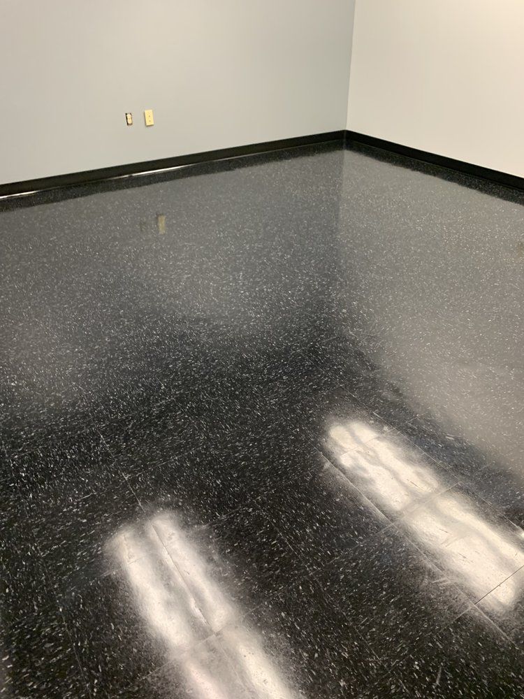 A room with a black floor and white walls.