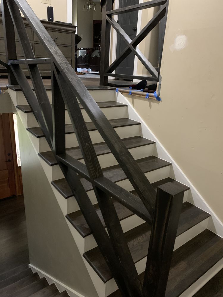 A wooden staircase with a metal railing in a house