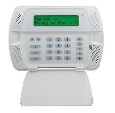 A white keypad with a green screen that says `` system is ready to arm ''.