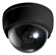 A black dome security camera with a white light coming out of it.