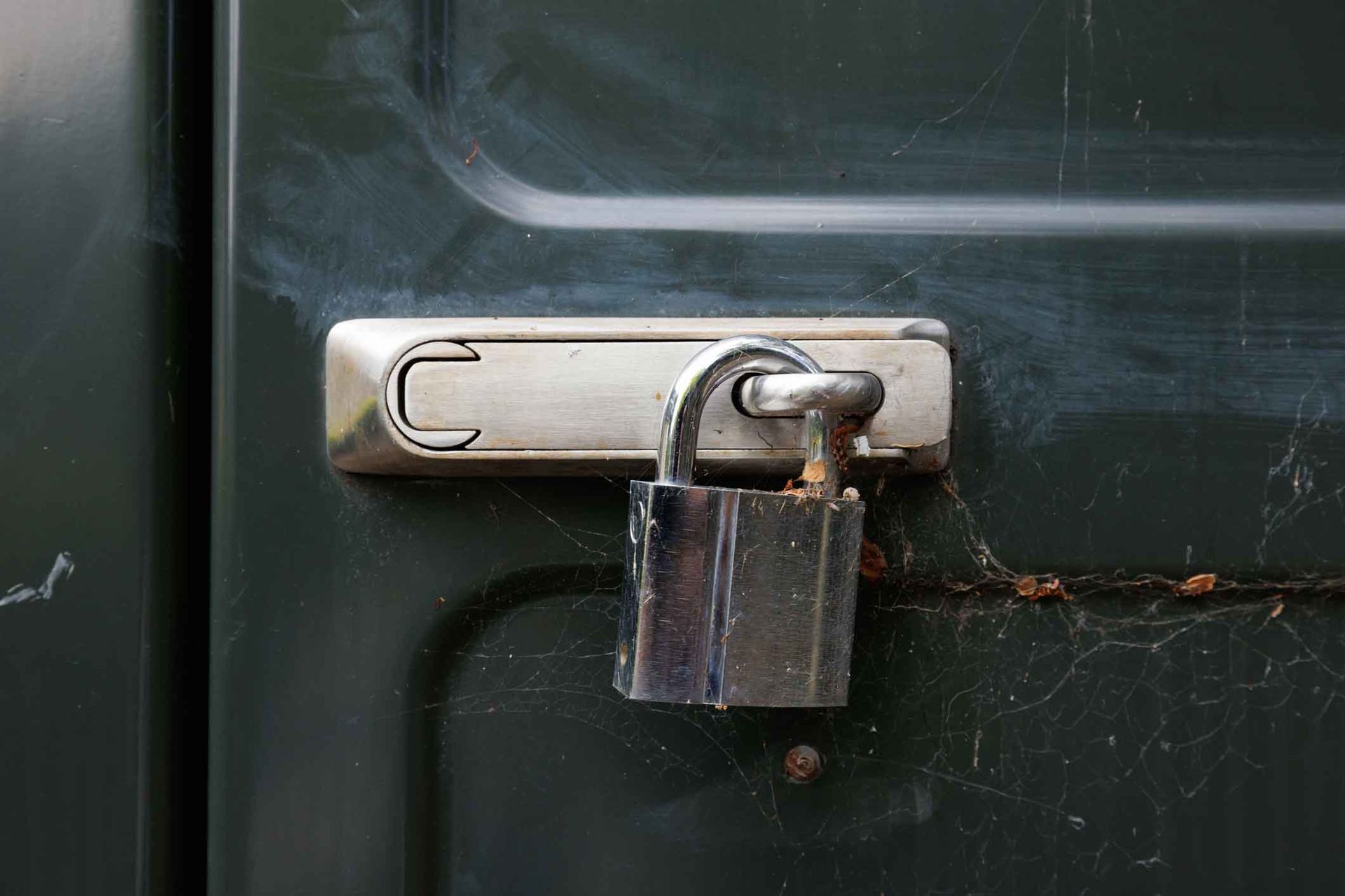 A close up of a padlock on a door.