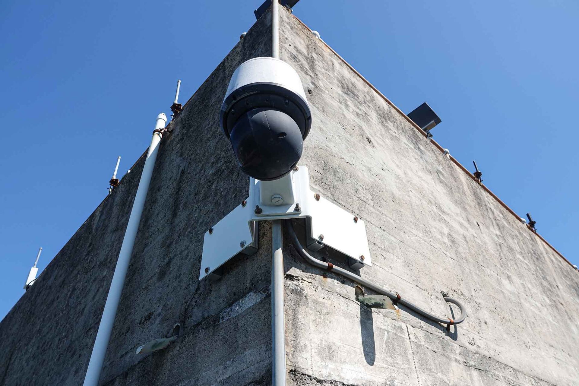 A security camera mounted on the side of a building