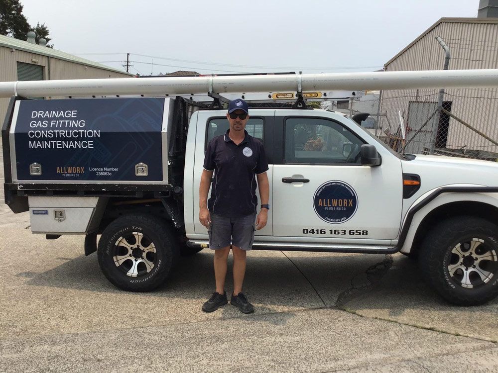 Man Standing Beside The Pick Up Truck — Promotional Apparel In Woonona, NSW