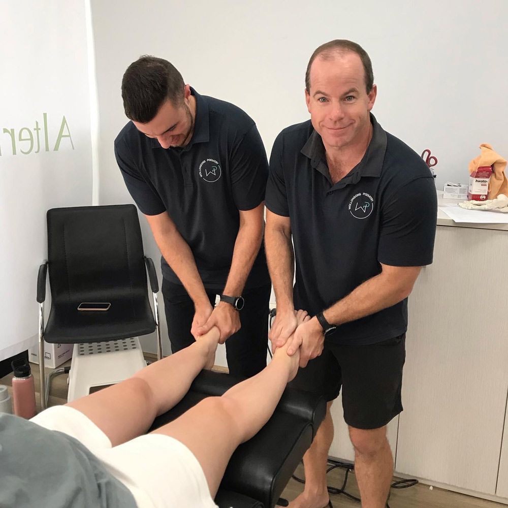 Two Men Doing Foot Massage Wearing Promotion T-Shirt — Promotional Apparel In Shellharbour, NSW