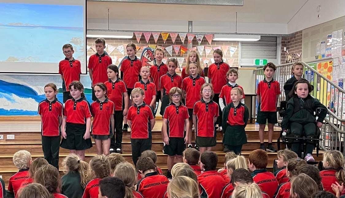 Kids Wearing Red Polo Shirts At The Stage — Promotional Apparel In Woonona, NSW