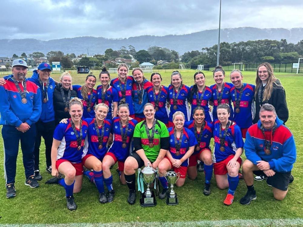 Group Of People Wearing Their Sports Attire With Medals At The Open Field — Promotional Apparel In Woonona, NSW
