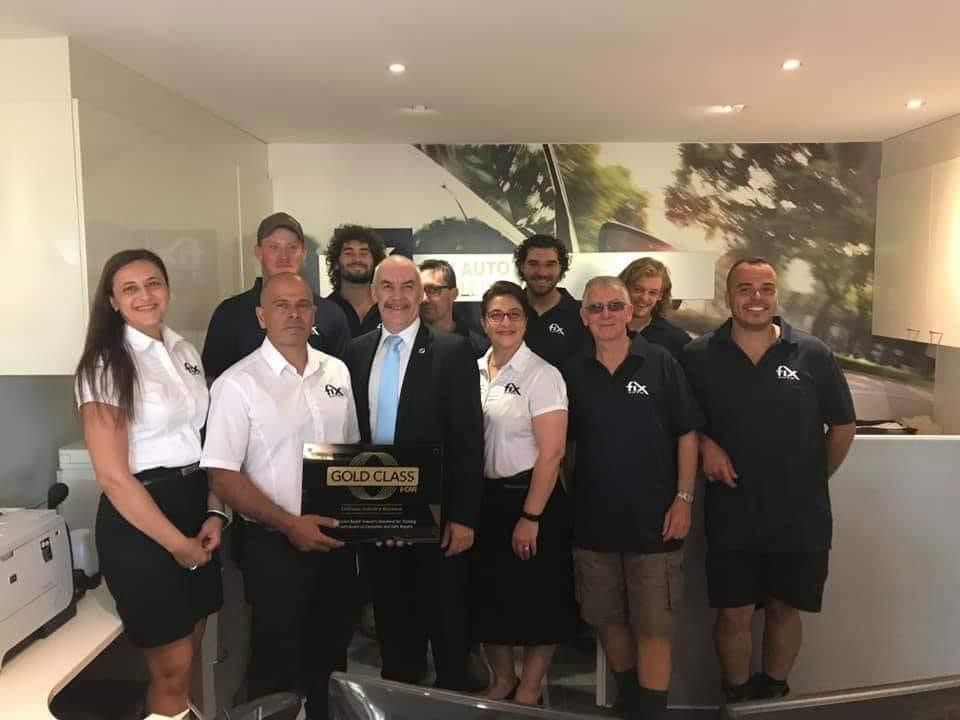 Individuals Showcasing Corporate Attire and Polo Shirts in an Office Setting — Promotional Apparel In Woonona, NSW
