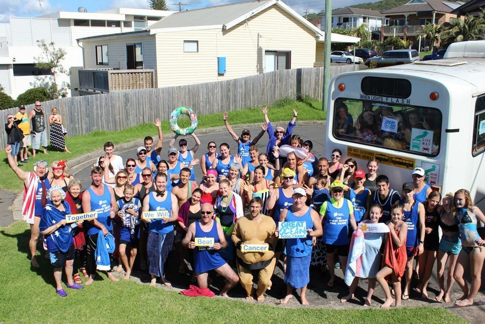 Group Picture With Bus And House Background — Promotional Apparel In Woonona, NSW