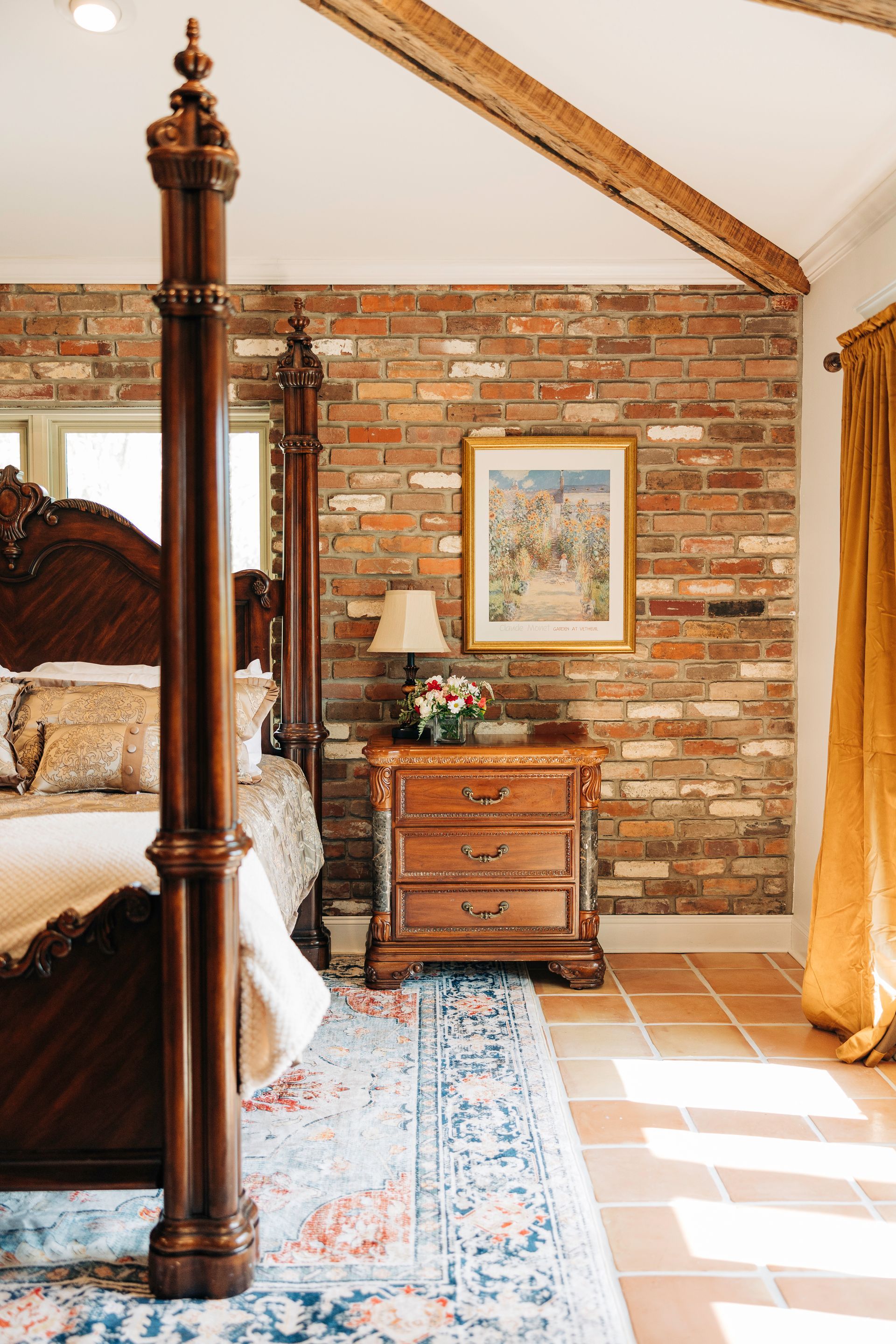A bedroom with a bed , nightstand , and window.