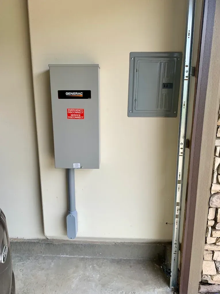 Electrical panel and breaker box on a beige wall in a garage.