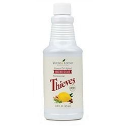 Bottle of Young Living Thieves household cleaner with lemon and spice illustrations.