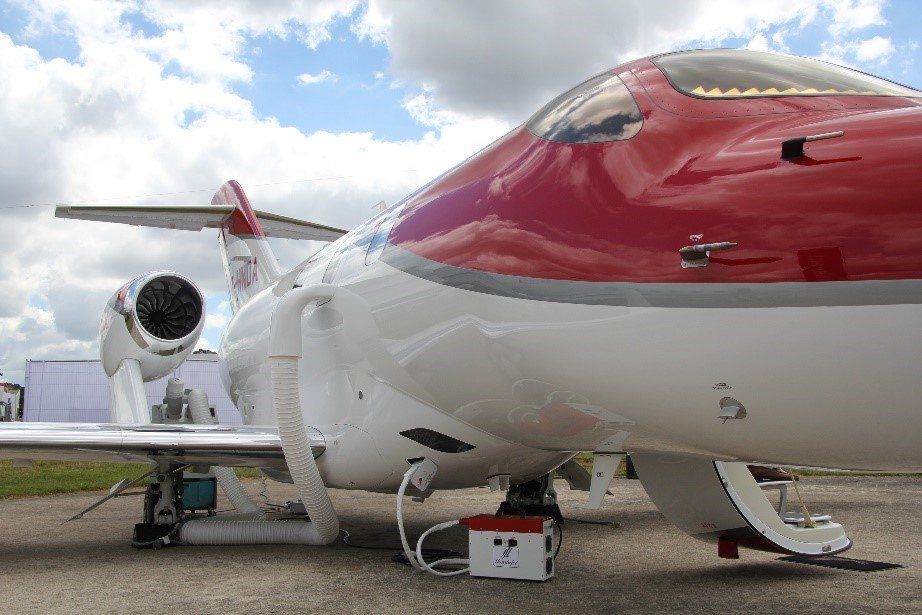 Red airplane being charged on ground
