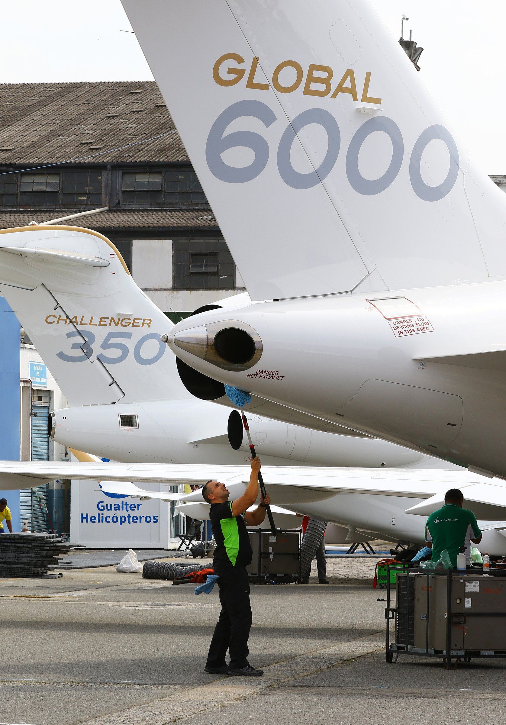 Levon Aviation worker cleaning airplane tail