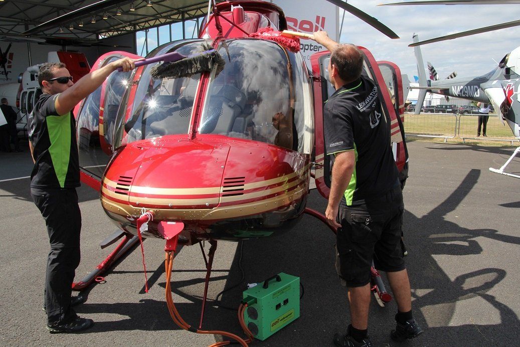 Levon Aviation workers cleaning an helicopter